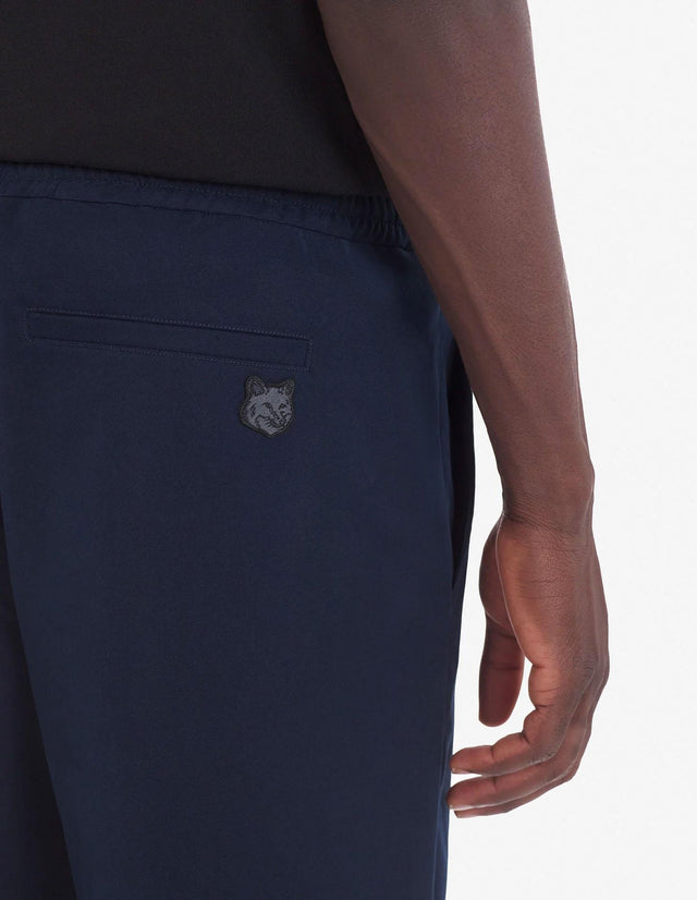 CITY PANTS IN COTTON GABARDINE WITH BOLD FOX HEAD PATCH - INK BLUE LM01111WW0085 INK BLUE Maison Kitsune 